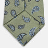 View 4 of product The Green Renoir Paisley Tie by Turnbull & Asser is a pistachio green jacquard tie with blue and black paisley motifs on a light background.