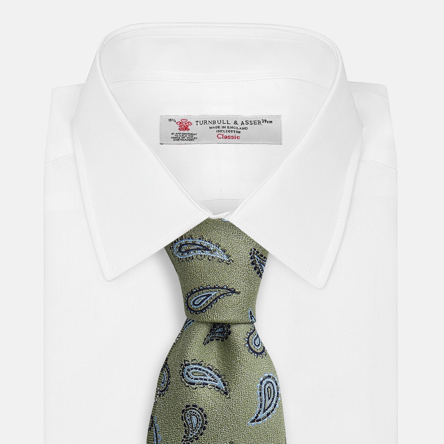 View 2 of product The Green Renoir Paisley Tie by Turnbull & Asser is a pistachio green jacquard tie with blue and black paisley motifs on a light background.