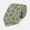 View 1 of product The Green Renoir Paisley Tie by Turnbull & Asser is a pistachio green jacquard tie with blue and black paisley motifs on a light background.