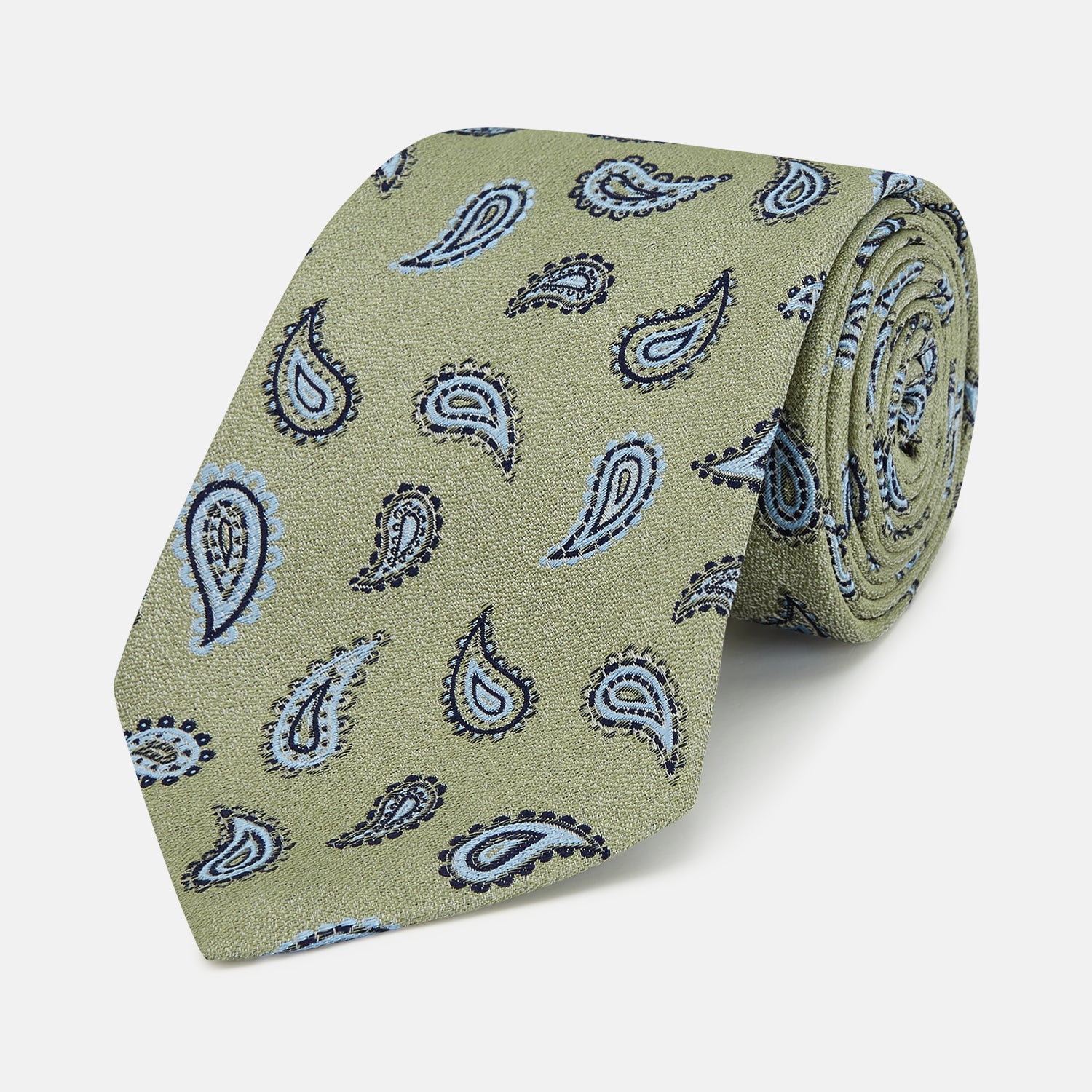 View 1 of product The Green Renoir Paisley Tie by Turnbull & Asser is a pistachio green jacquard tie with blue and black paisley motifs on a light background.