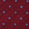 View 3 of product The Turnbull & Asser Red Square Silk Tie features a red and blue pattern with small white squares, elegantly rolled and displayed on a plain white background—a refined choice for men's accessories.