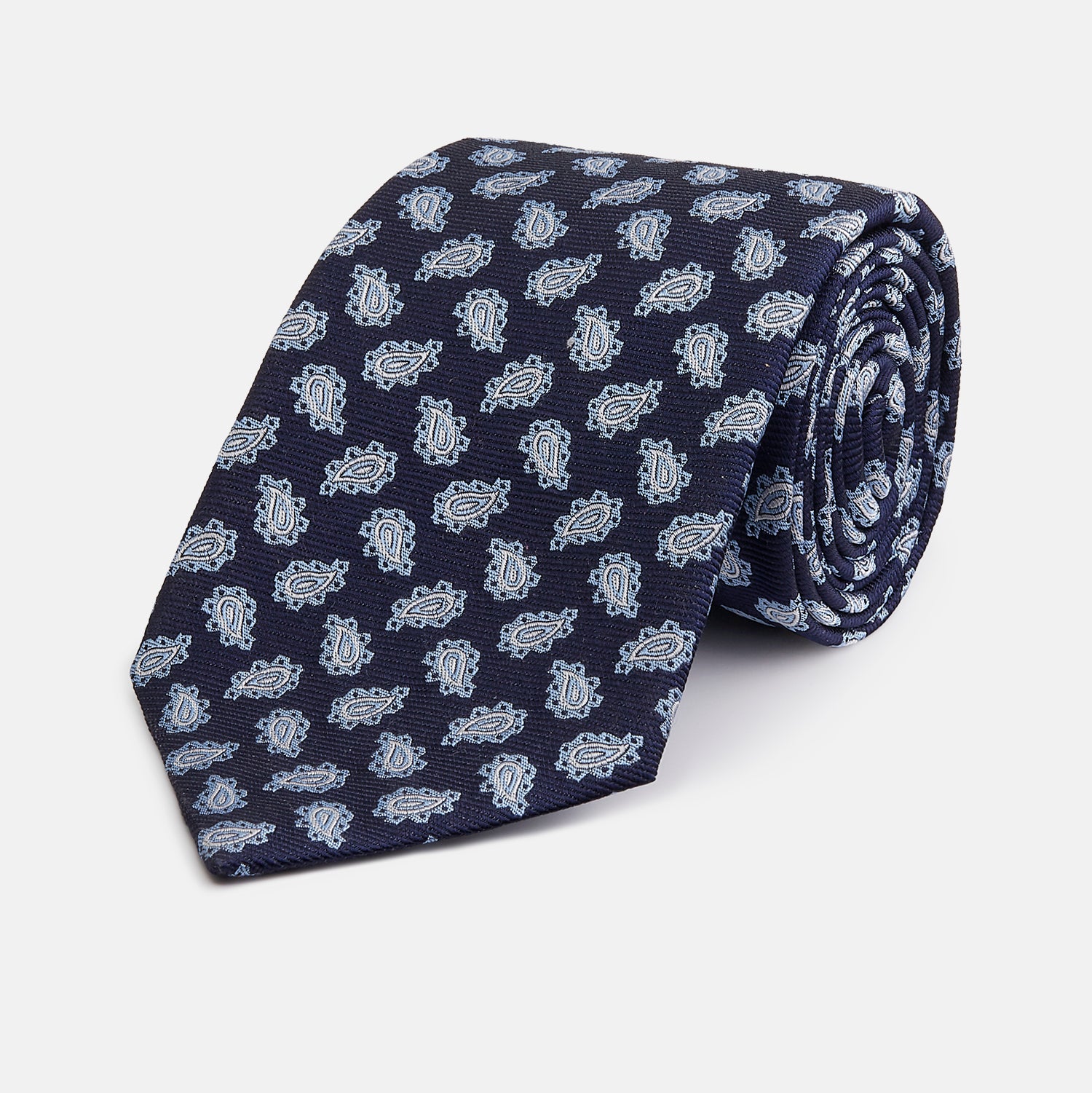 View 1 of product The Blue Abstract Paisley Silk Tie by Turnbull & Asser features a classic paisley motif in navy, offering a timeless touch to your wardrobe and perfectly capturing traditional elegance.