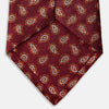 View 4 of product The Turnbull & Asser Red Abstract Paisley Silk Tie features bold orange and white paisley patterns on rich red silk—a stylish choice for fans of classic tailoring.
