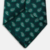 View 4 of product The Turnbull & Asser Green Abstract Paisley Silk Tie features a repeating light green paisley pattern on dark green silk, shown rolled up against a white background—a refined men’s accessory for making a statement.