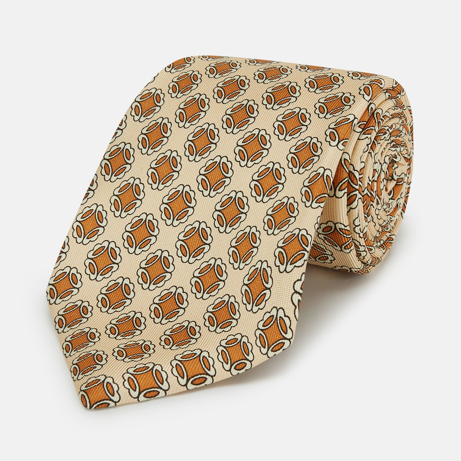 View 1 of product A cream floral geometric tie by Turnbull & Asser, rolled with the pointed end forward, is displayed on a white background.