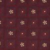 View 3 of product The Turnbull & Asser Burgundy Illusion Flower Silk Tie features a geometric pattern of small yellow and white dots within diamond shapes, elegantly displayed rolled up on a light background.