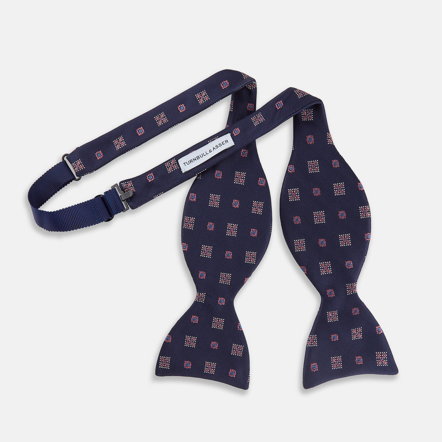 View 4 of product The Turnbull & Asser Pink Shields Bow Tie features a pink pattern with shield motifs, ideal for formal occasions and displayed on a plain white background.