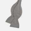 View 2 of product The Turnbull & Asser Fine Puppytooth Monochrome Silk Bow Tie, shown on a white background, features a black and white puppytooth pattern—ideal for wearing with formalwear or an evening shirt.