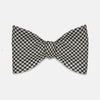 View 1 of product The Turnbull & Asser Fine Puppytooth Monochrome Silk Bow Tie, shown on a white background, features a black and white puppytooth pattern—ideal for wearing with formalwear or an evening shirt.