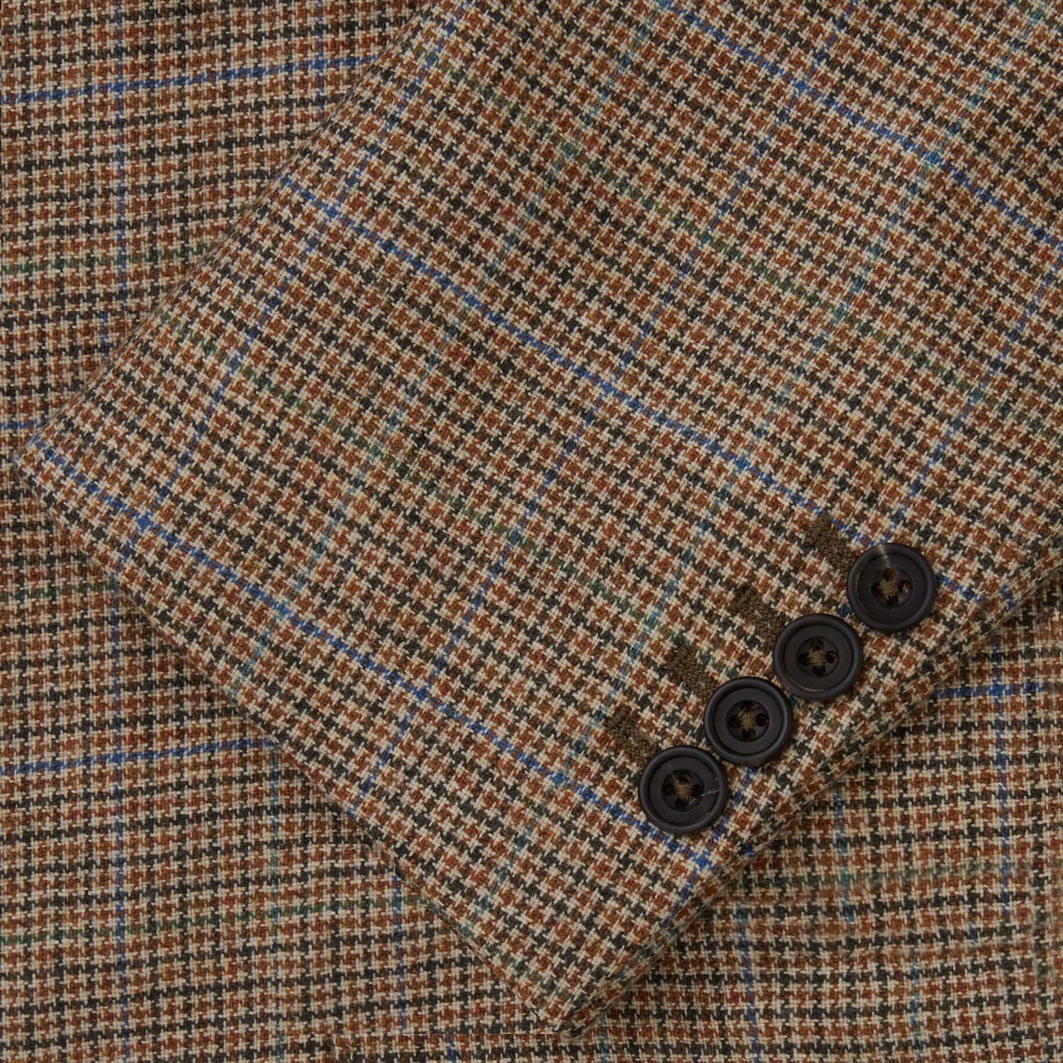View 5 of product The Byron Wool Check Travel Jacket by Turnbull & Asser features a brown plaid pattern, notched lapel, four flap utility pockets, and dark buttons. This lightweight wool jacket is shown on a plain white background.