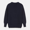 View 6 of product A man stands in the Turnbull & Asser Navy Lewis Guernsey Knitted Jumper.