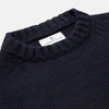 View 3 of product A man stands in the Turnbull & Asser Navy Lewis Guernsey Knitted Jumper.