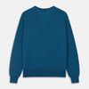 View 3 of product The Turnbull & Asser Ocean Blue Merino Kennedy V-Neck Jumper, shown flat on a white background, features ribbed cuffs and hem with a visible branded label at the neckline.