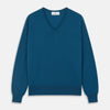 View 1 of product The Turnbull & Asser Ocean Blue Merino Kennedy V-Neck Jumper, shown flat on a white background, features ribbed cuffs and hem with a visible branded label at the neckline.