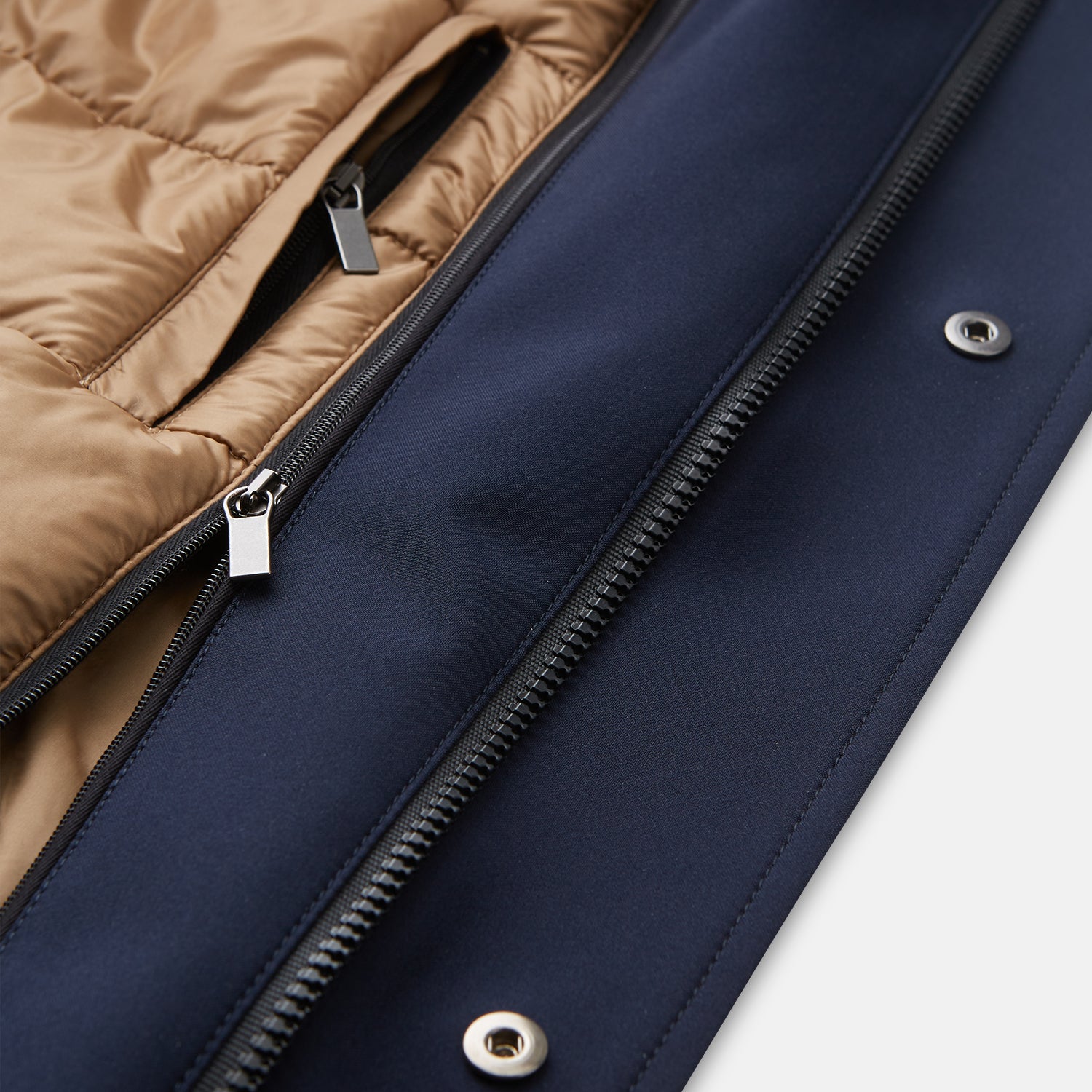 View 4 of product The Turnbull & Asser Navy Walter Sealup Parka with Detachable Liner features silver snap buttons, front flap pockets, and a drawstring hem. Styled against a white background, this waterproof parka offers both elegance and practicality for wet weather.