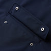 View 3 of product The Turnbull & Asser Navy Walter Sealup Parka with Detachable Liner features silver snap buttons, front flap pockets, and a drawstring hem. Styled against a white background, this waterproof parka offers both elegance and practicality for wet weather.