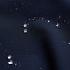 View 5 of product The Turnbull & Asser Navy Walter Sealup Parka with Detachable Liner features silver snap buttons, front flap pockets, and a drawstring hem. Styled against a white background, this waterproof parka offers both elegance and practicality for wet weather.