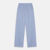 View 2 of product A man stands barefoot against a plain background, wearing a white short-sleeve T-shirt and Turnbull & Asser Blue Stripe Cotton Pyjama Trousers in a contemporary fit, looking straight ahead with a neutral expression.