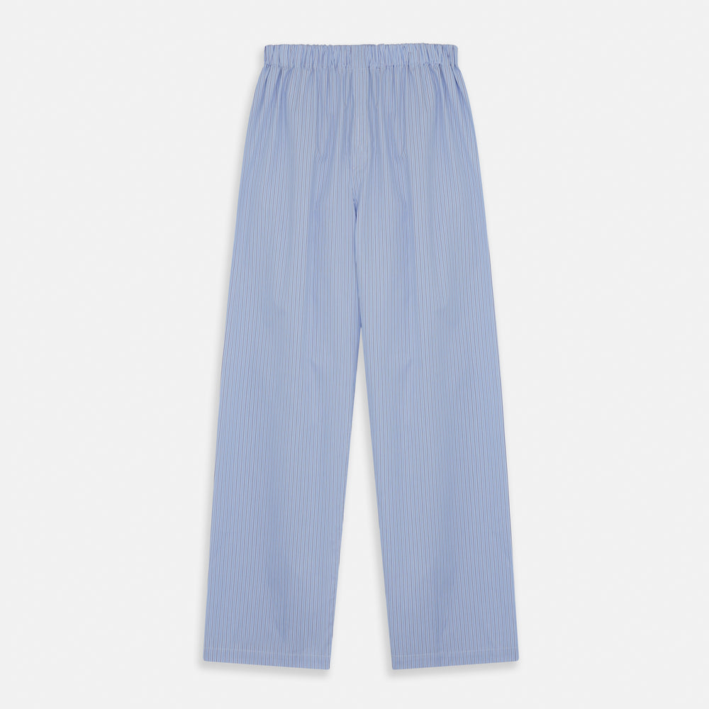 A man stands barefoot against a plain background, wearing a white short-sleeve T-shirt and Turnbull & Asser Blue Stripe Cotton Pyjama Trousers in a contemporary fit, looking straight ahead with a neutral expression.