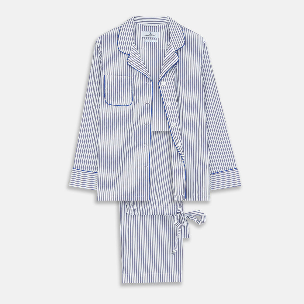 The Women's Dara Navy Stripe Pyjama Set by Turnbull & Asser features a long-sleeve button-up shirt with chest pocket and drawstring pants in premium cotton, shown neatly on a white background.