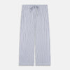View 4 of product The Women's Dara Navy Stripe Pyjama Set by Turnbull & Asser features a long-sleeve button-up shirt with chest pocket and drawstring pants in premium cotton, shown neatly on a white background.