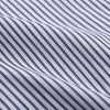 View 5 of product The Women's Dara Navy Stripe Pyjama Set by Turnbull & Asser features a long-sleeve button-up shirt with chest pocket and drawstring pants in premium cotton, shown neatly on a white background.