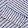 View 3 of product The Women's Dara Navy Stripe Pyjama Set by Turnbull & Asser features a long-sleeve button-up shirt with chest pocket and drawstring pants in premium cotton, shown neatly on a white background.