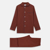 View 2 of product The Turnbull & Asser Red Cotton-Cashmere Pyjama Set features a rust-red long-sleeve button-up top with chest pocket and matching waist-tied pants, shown on a plain white background.