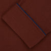 View 4 of product The Turnbull & Asser Red Cotton-Cashmere Pyjama Set features a rust-red long-sleeve button-up top with chest pocket and matching waist-tied pants, shown on a plain white background.