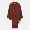 View 1 of product The Turnbull & Asser Red Cotton-Cashmere Pyjama Set features a rust-red long-sleeve button-up top with chest pocket and matching waist-tied pants, shown on a plain white background.