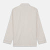View 7 of product The Turnbull & Asser Sand Bengal Stripe Modern Fit Cotton Pyjama Set features cream-colored striped Italian cotton, with a long-sleeved button-up top and matching drawstring pants, neatly displayed against a white background.