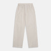 View 5 of product The Turnbull & Asser Sand Bengal Stripe Modern Fit Cotton Pyjama Set features cream-colored striped Italian cotton, with a long-sleeved button-up top and matching drawstring pants, neatly displayed against a white background.