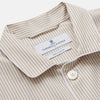 View 2 of product The Turnbull & Asser Sand Bengal Stripe Modern Fit Cotton Pyjama Set features cream-colored striped Italian cotton, with a long-sleeved button-up top and matching drawstring pants, neatly displayed against a white background.