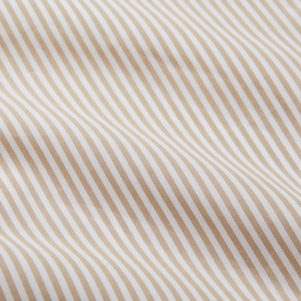 The Turnbull & Asser Sand Bengal Stripe Modern Fit Cotton Pyjama Set features cream-colored striped Italian cotton, with a long-sleeved button-up top and matching drawstring pants, neatly displayed against a white background.