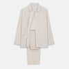 View 1 of product The Turnbull & Asser Sand Bengal Stripe Modern Fit Cotton Pyjama Set features cream-colored striped Italian cotton, with a long-sleeved button-up top and matching drawstring pants, neatly displayed against a white background.
