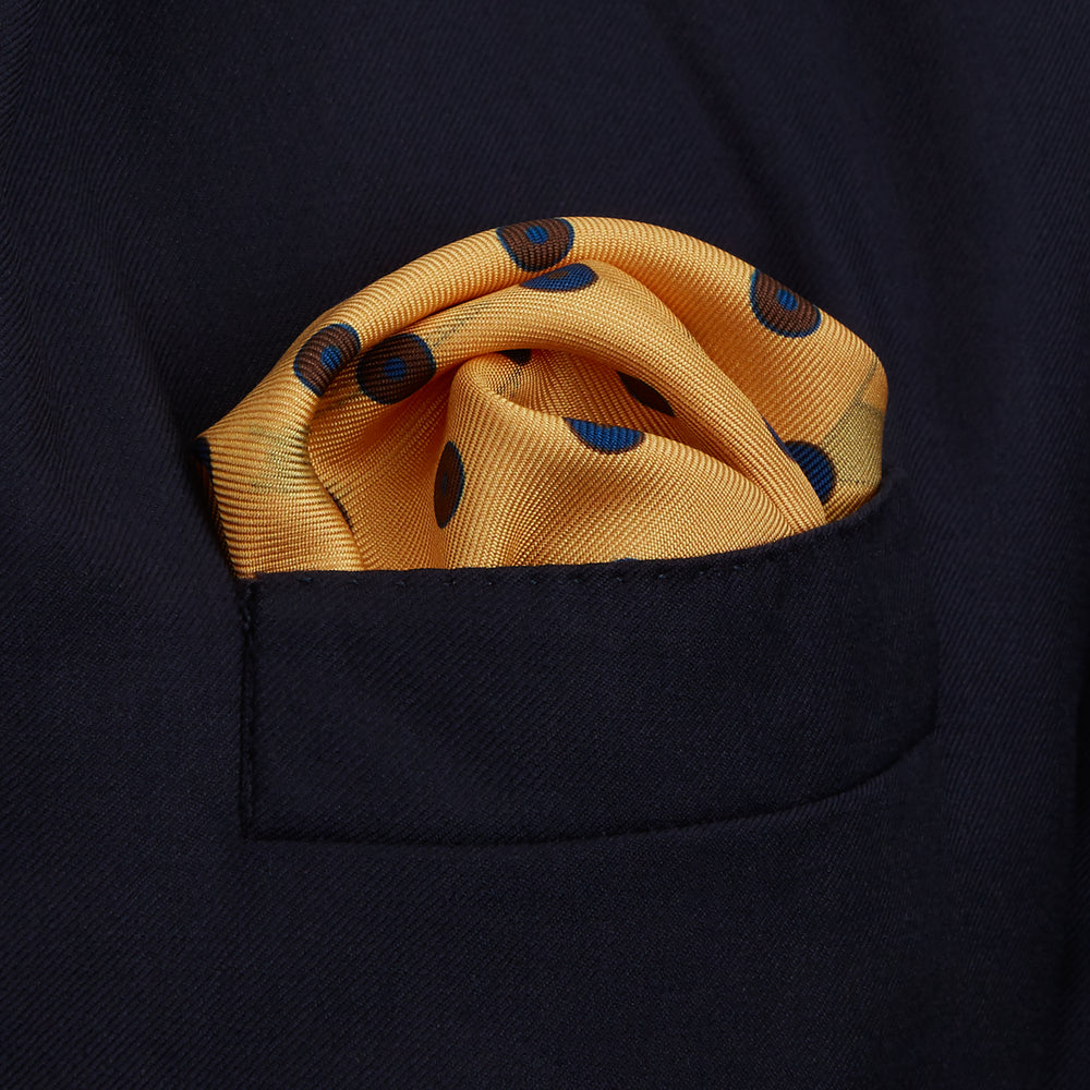 The Turnbull & Asser Yellow Windsurfer Double-Faced Silk Print Pocket Square features playful windsurfers on yellow silk, with a contrasting edge for a refined touch.