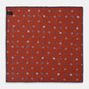 View 2 of product The Turnbull & Asser Red Windsurfer Double-Faced Silk Print Pocket Square features a vibrant windsurfer pattern on silk with a dark blue border and the brand subtly printed in one corner.