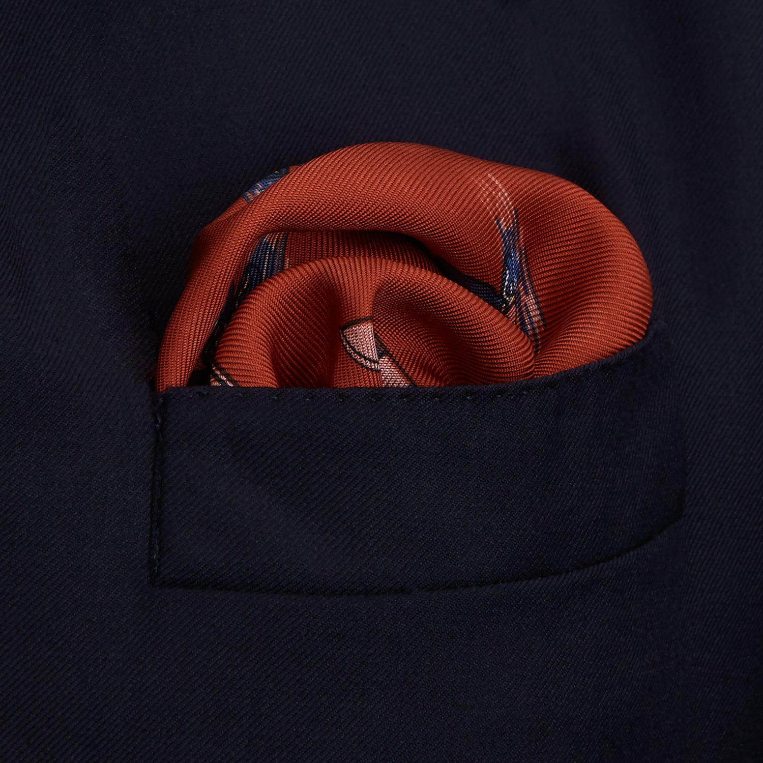 View 4 of product The Turnbull & Asser Red Windsurfer Double-Faced Silk Print Pocket Square features a vibrant windsurfer pattern on silk with a dark blue border and the brand subtly printed in one corner.