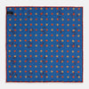 View 2 of product The Turnbull & Asser Blue Windsurfer Double-Faced Silk Print Pocket Square features a blue silk design with colorful windsurfers and vivid red edges, finished with the Turnbull & Asser logo in one corner.