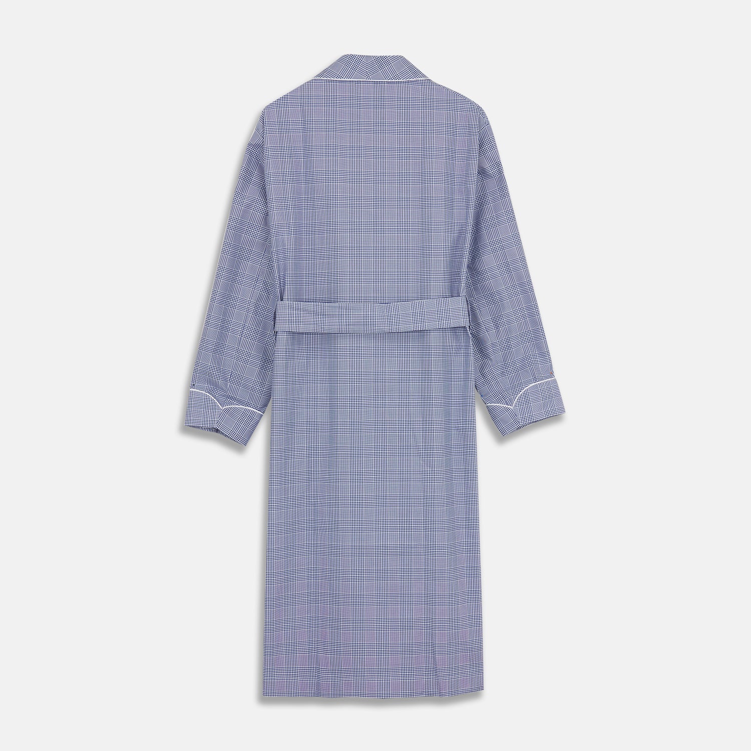View 5 of product The Turnbull & Asser Navy Check Cotton Gown features long sleeves, white piping, a shawl collar, chest pocket, and matching waist belt, all in a blue plaid pattern. Shown against a plain white background.