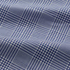View 4 of product The Turnbull & Asser Navy Check Cotton Gown features long sleeves, white piping, a shawl collar, chest pocket, and matching waist belt, all in a blue plaid pattern. Shown against a plain white background.