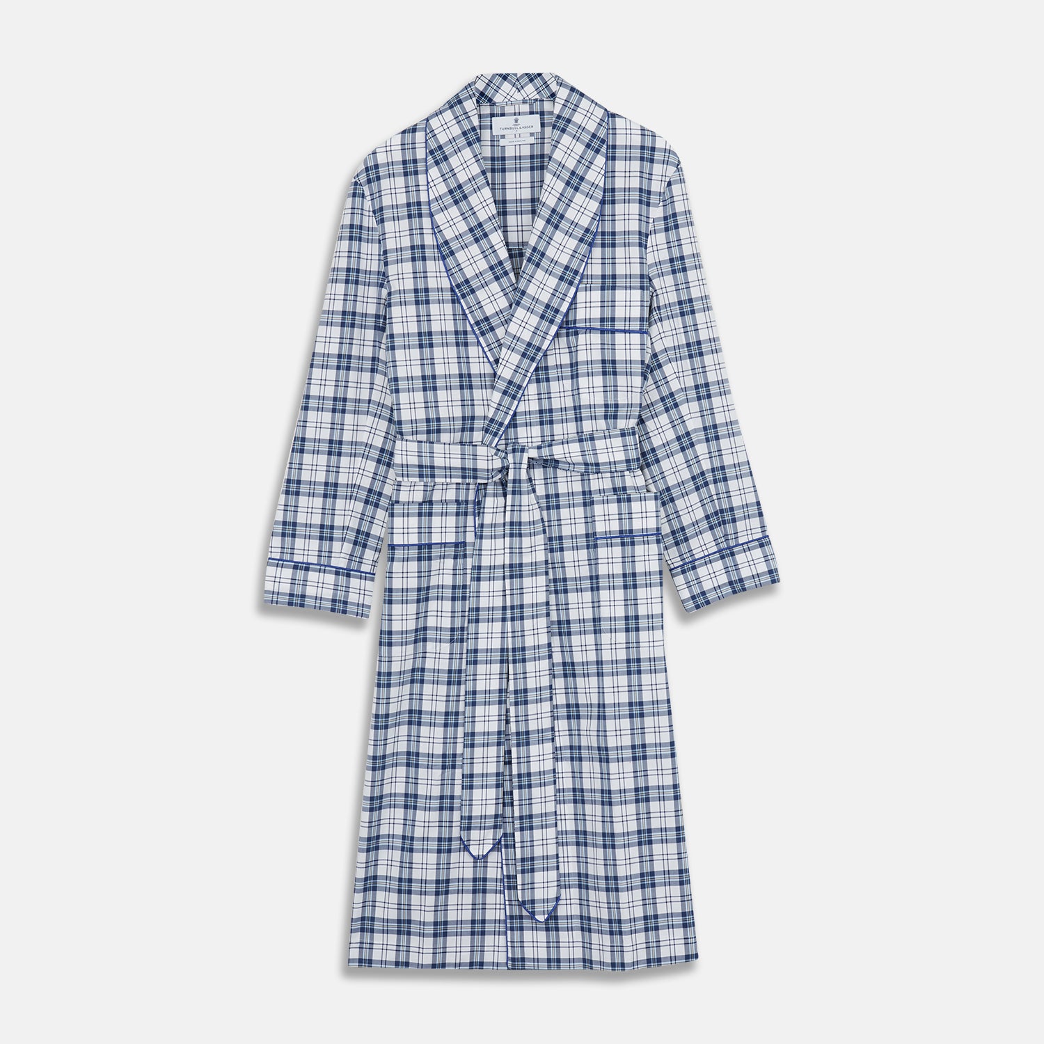 View 1 of product The Turnbull & Asser Blue Check Cotton Gown features long sleeves, a knee-length cut, shawl collar, and matching waist belt in a blue check pattern, shown against a plain white background.