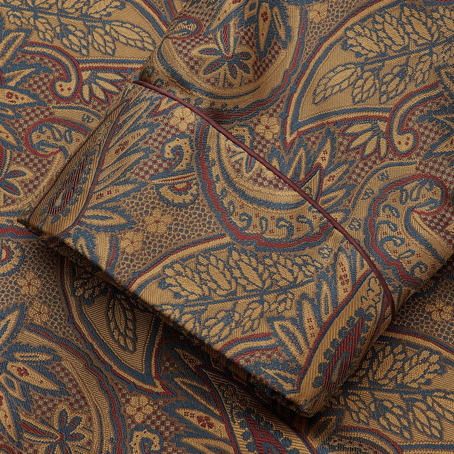 View 3 of product The Turnbull & Asser Gold Paisley Traditional Silk Jacquard Gown features a brown and gold paisley pattern, shawl collar, front pockets, and matching fabric belt. Displayed on a white background, it’s perfect for winter comfort.