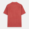 View 5 of product The Turnbull & Asser Crimson Delave Linen Holiday Fit Shirt features a solid brick-red hue, short sleeves, single chest pocket, and revere collar—perfect resort wear—shown laid flat on white.