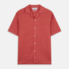 View 1 of product The Turnbull & Asser Crimson Delave Linen Holiday Fit Shirt features a solid brick-red hue, short sleeves, single chest pocket, and revere collar—perfect resort wear—shown laid flat on white.