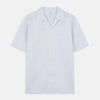 View 1 of product The Turnbull & Asser Blue Linen Stripe Holiday Fit Shirt features short sleeves, a revere collar, and single chest pocket, perfect for resort wear. Shown on a plain white background.