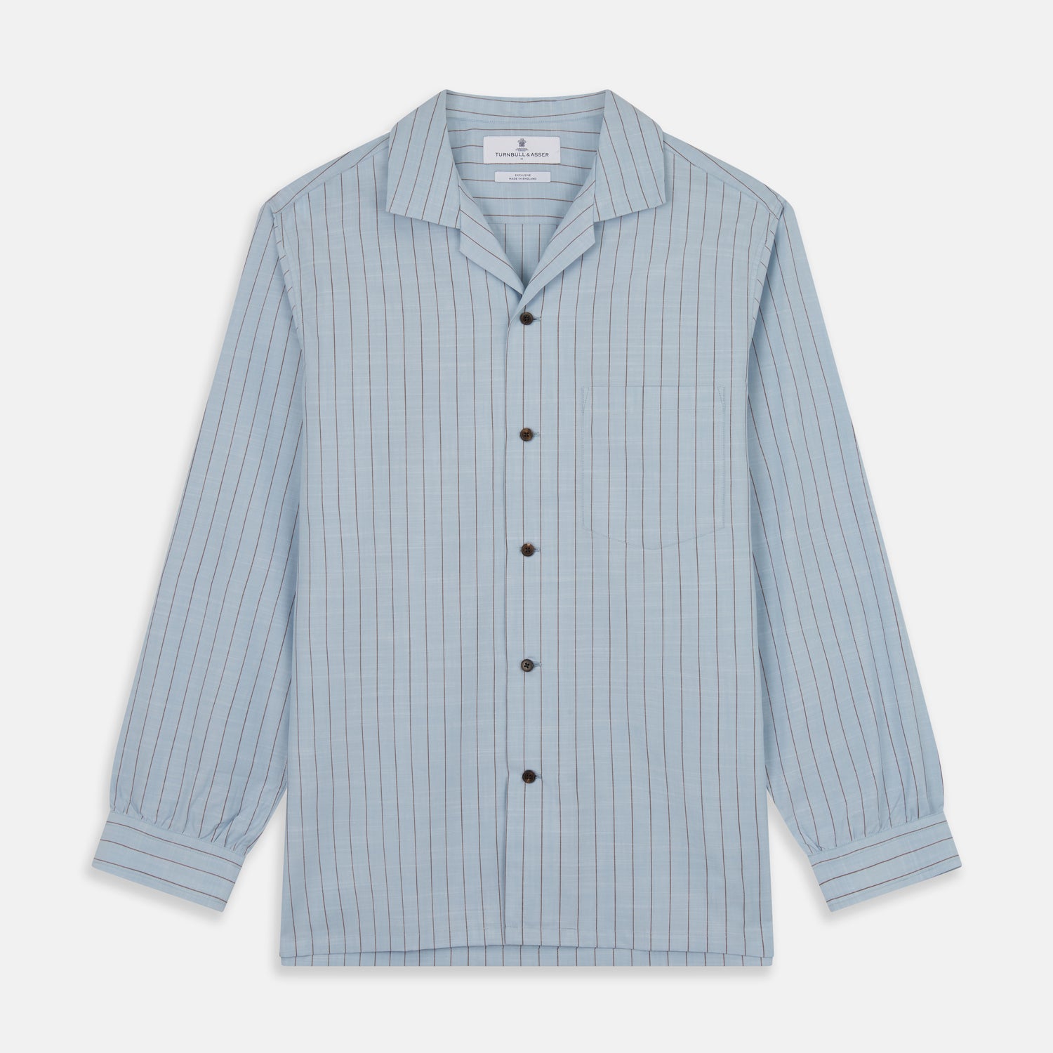 View 1 of product Turnbull & Asser's Pale Blue Stripe Cotton Holiday Fit Shirt features a revere collar, thin black pinstripes, single button cuff, chest pocket, and black buttons—crafted from Italian cotton and laid flat on a white background.