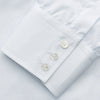 View 3 of product The Turnbull & Asser Pale Blue Stripe Regular Fit Sea Island Quality Cotton Shirt features a T&A collar and 3-button cuffs, laid flat on a white background.