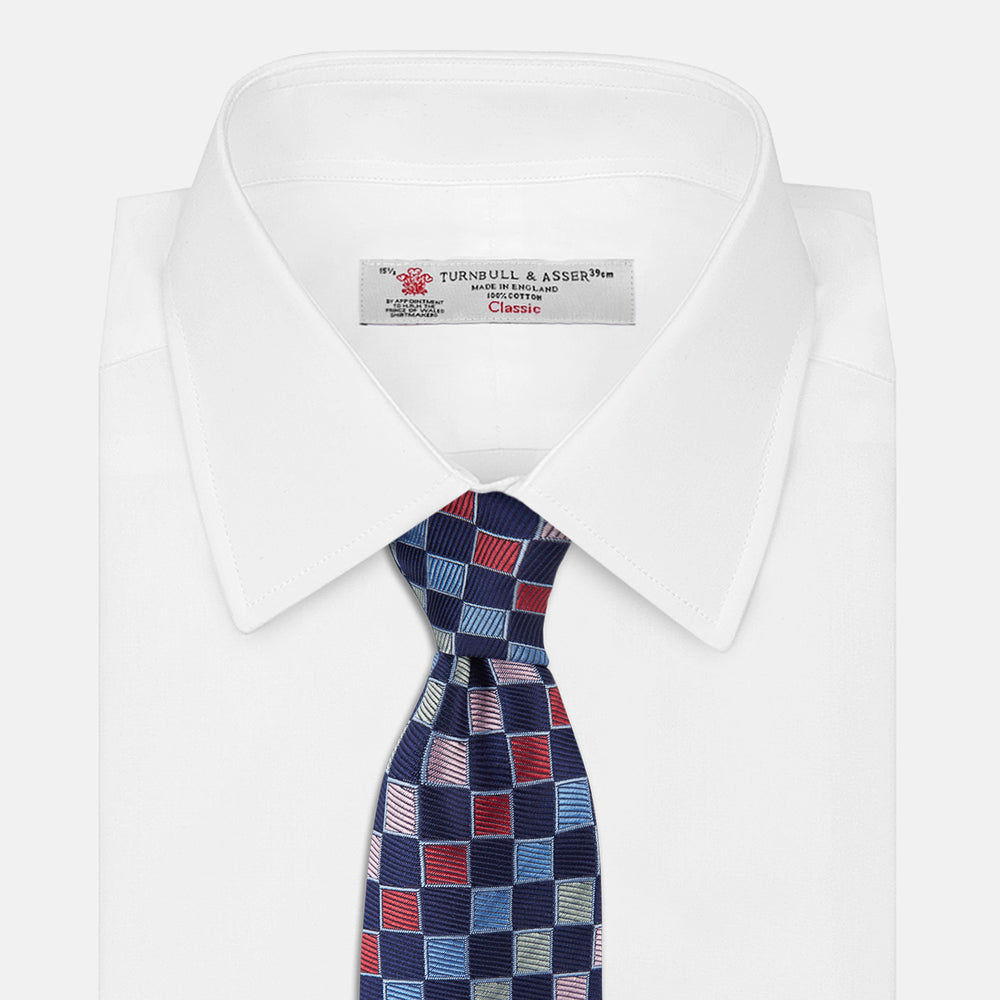 The Pink Multi Check Silk Tie by Turnbull & Asser features blue, red, and light green squares on a white background—an ideal summer accessory that complements bold shirts.