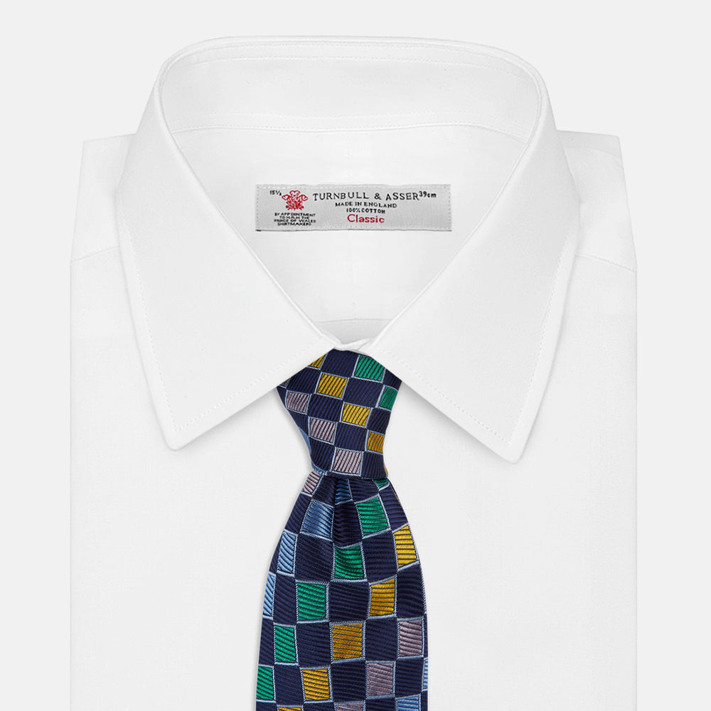 The Green Multi Check Silk Tie by Turnbull & Asser features a green checkered pattern with blue, yellow, and light purple squares on dark blue—ideal for bold shirts and a vibrant summer palette.